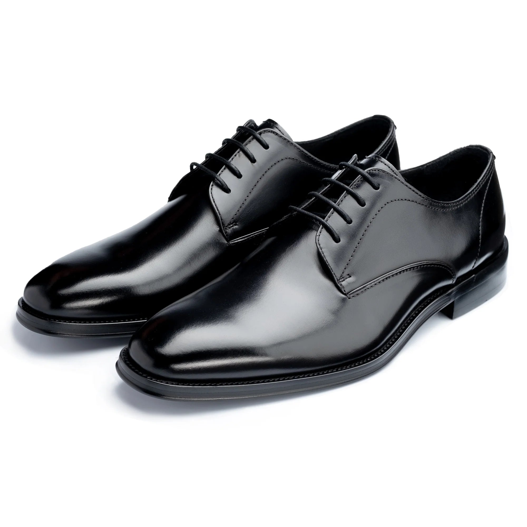 Pair of black dress shoes on a white background